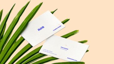 White business cards on palm leaves