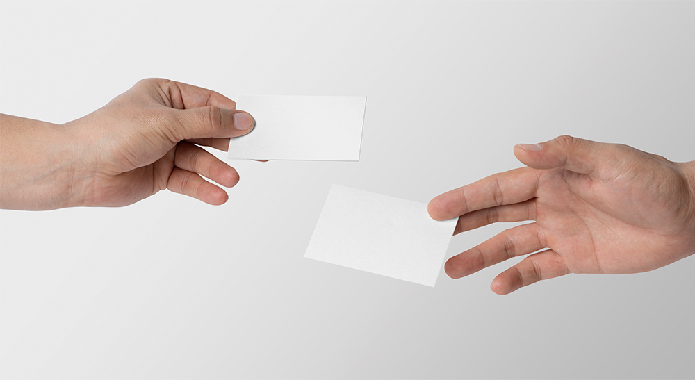 Plain white Two Hands sharing thier Business card nokia connecting