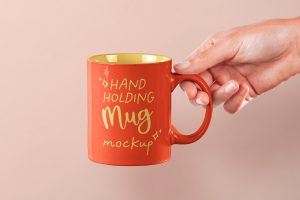 Free Hand Holding Mug PSD Mockup