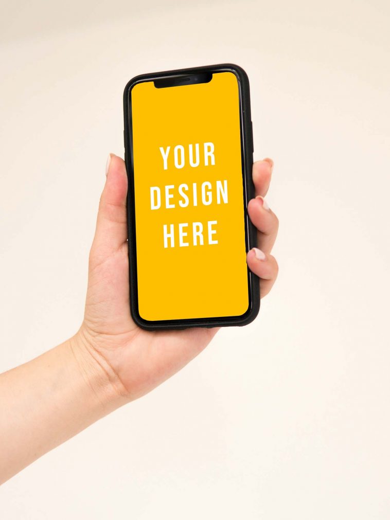Free iPhone Held in Hand Mockup PSD