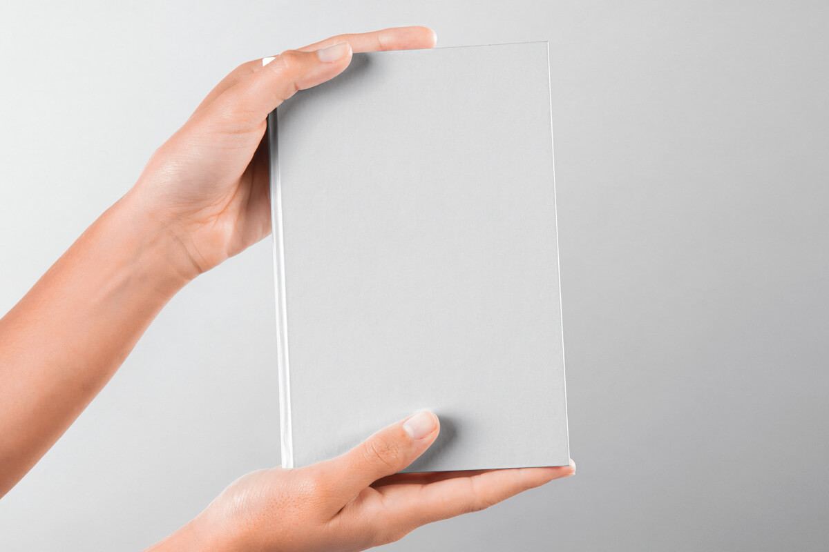 Hand Holding Hardcover Book Mockup