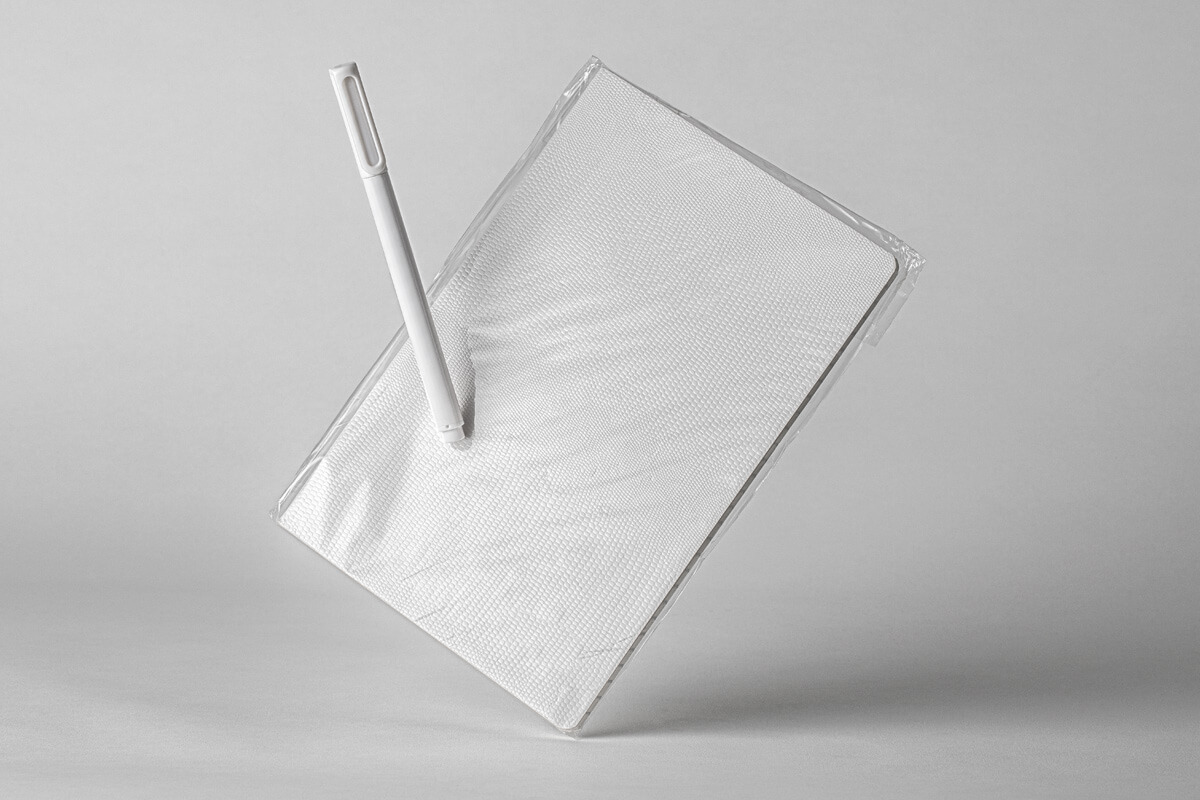 Mockup of a Notebook with Transparent Cover and a Pen