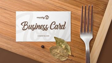 Overhead View of Business Card on Wooden Table Mockup