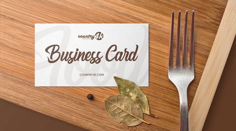 Overhead View of Business Card on Wooden Table Mockup