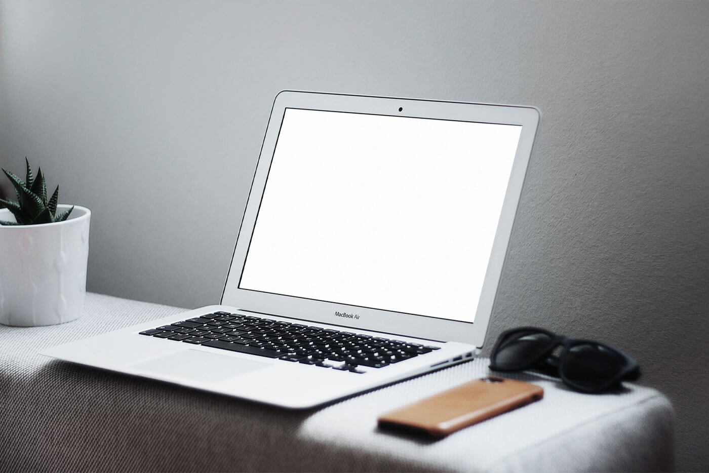 Interior View of MacBook on Table with Related Items Mockup 