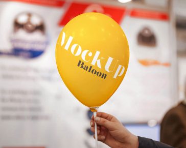 Free Hand Holding Balloon Mockup with Blurry Background