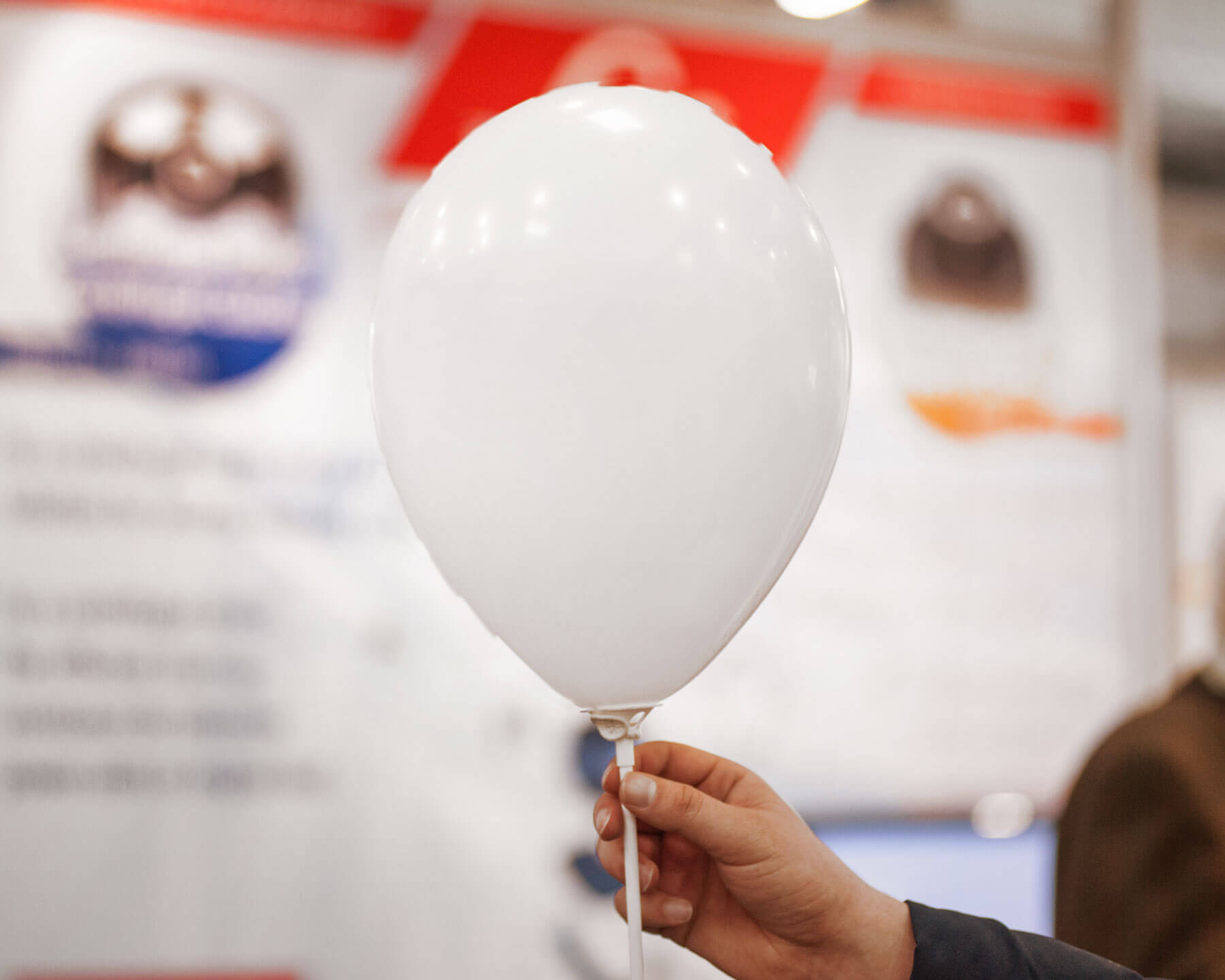 Mockup Showcasing Hand Holding Balloon with Blurry Background