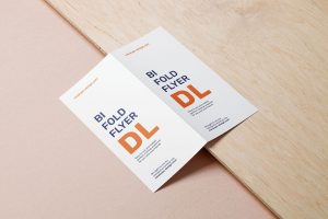 Bifold Dl Flyer Lying on a Wooden Board Mockup