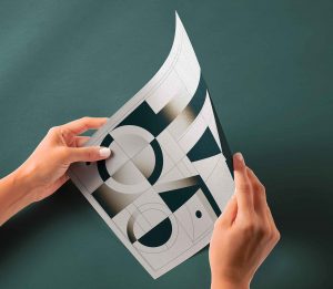 Free Hand Holding Glossy Paper Mockup PSD