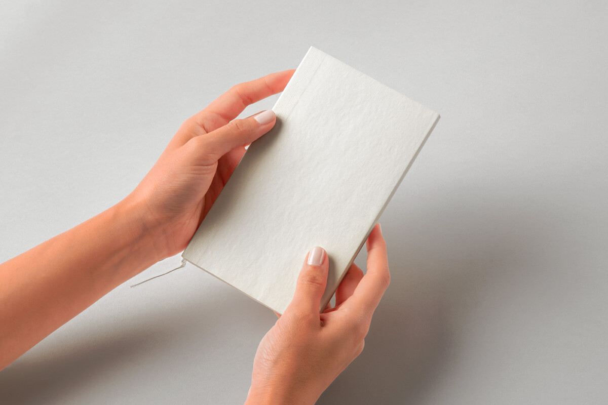 Cotton Hand Holding Notebook Mockup