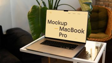 Free MacBook Pro On Small Table Mockup PSD
