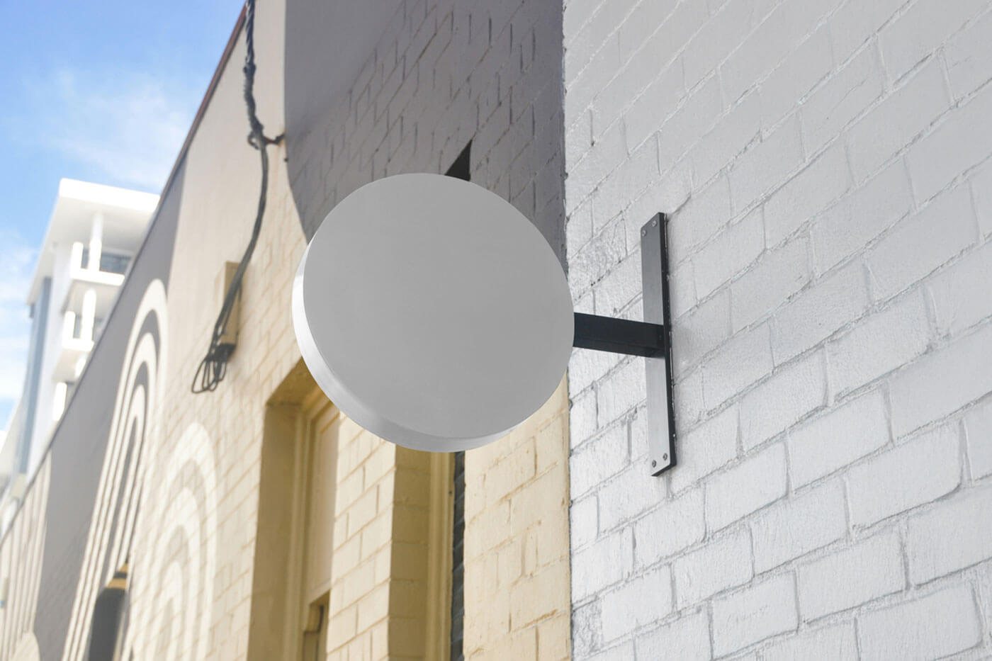 Free Wall-Mounted Round Shop Sign Mockup PSD